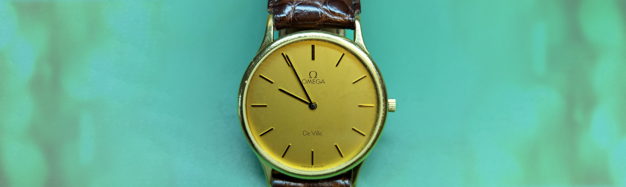 Omega De Ville Quartz Watch Repair on a turquoise background